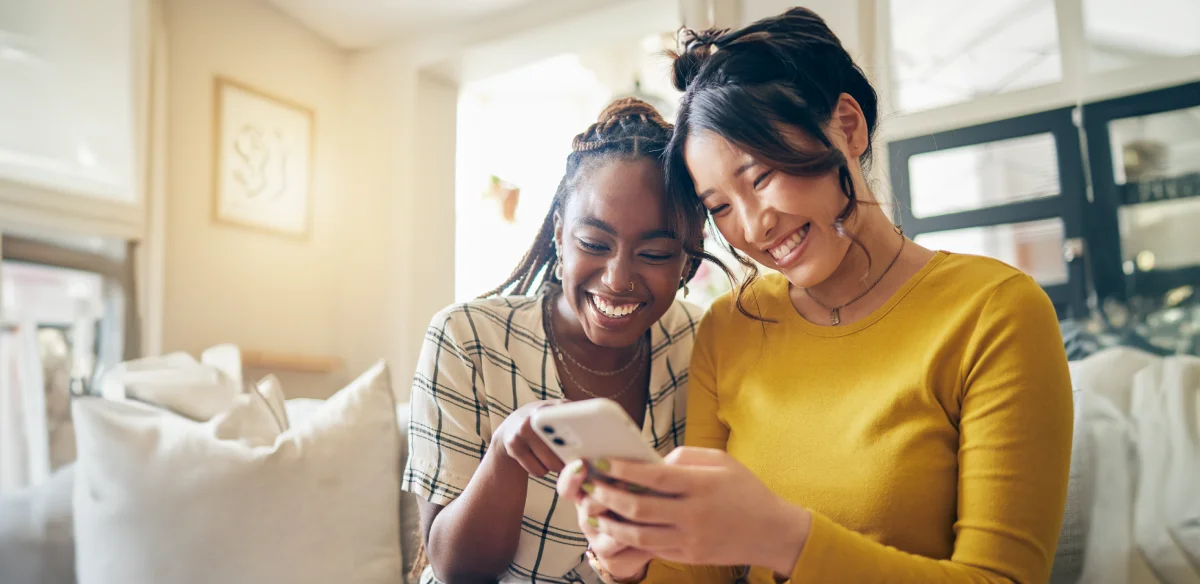 Two girls using a phone